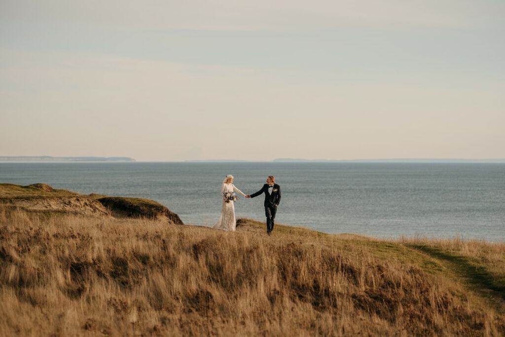 A couple walks along the ocean near Friday Harbor