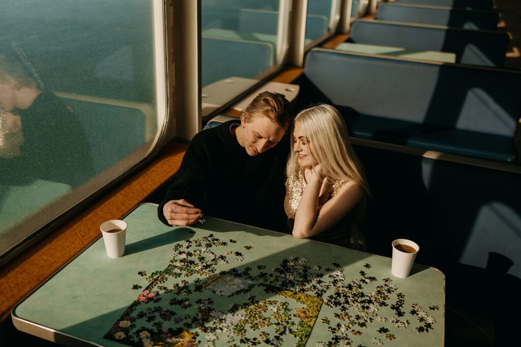 A couple puts a puzzle together while on the Washington Ferry to the San Juan Islands.