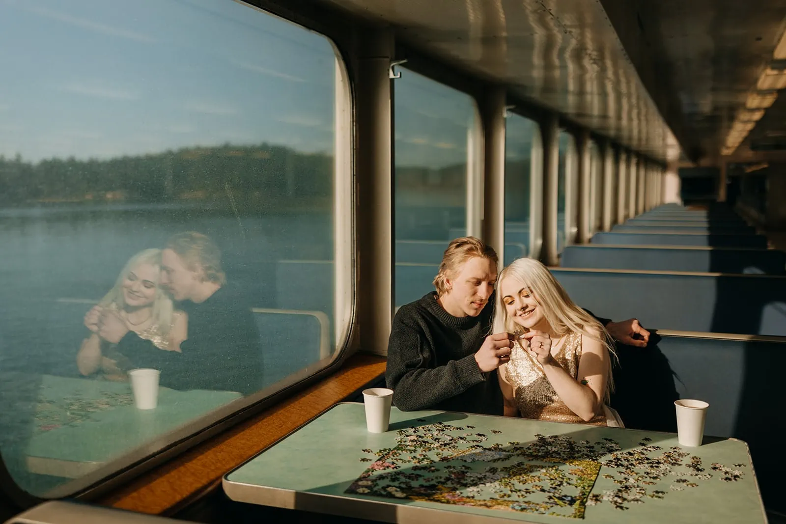 A couple plays puzzles while riding the washington state ferry on a sunny day to Friday Harbor.