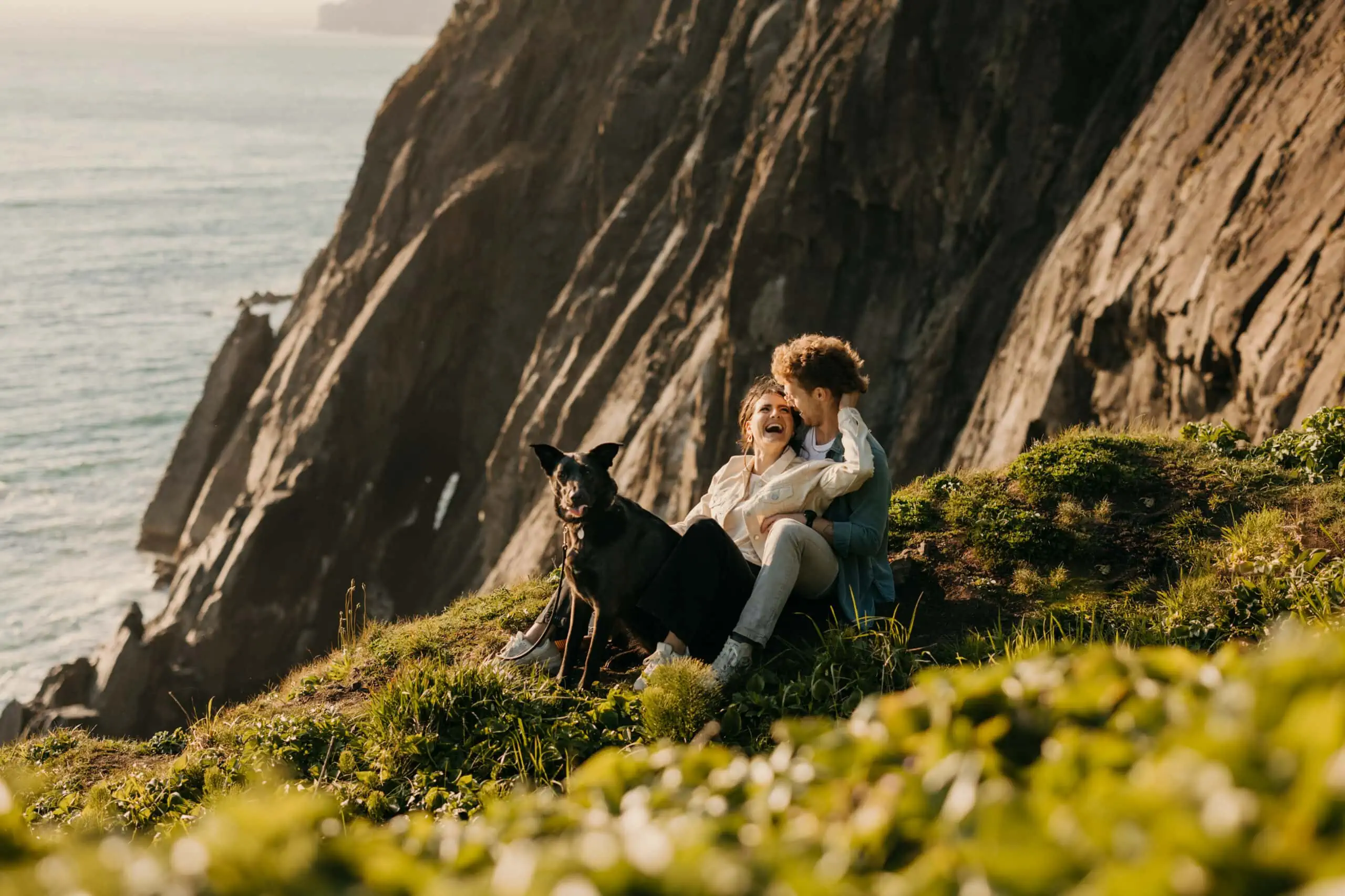 A couple and their dog enjoy the Oregon coast.