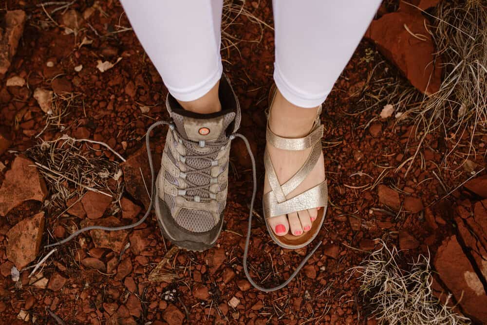 A bride wears one sandel and one hiking boot.