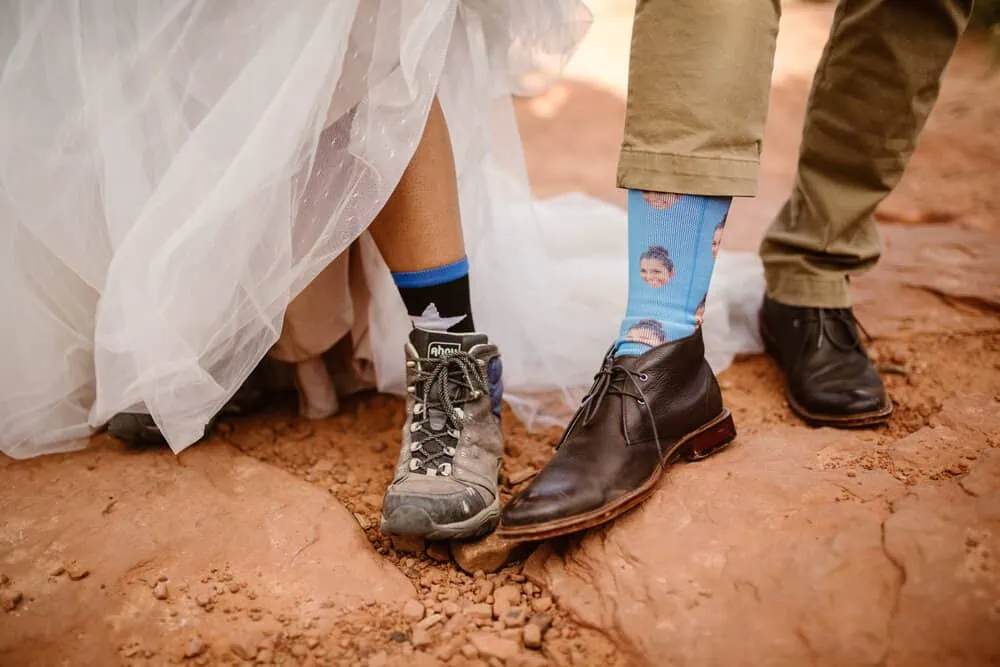 A bride and groom put their shoes together to show off their socks.