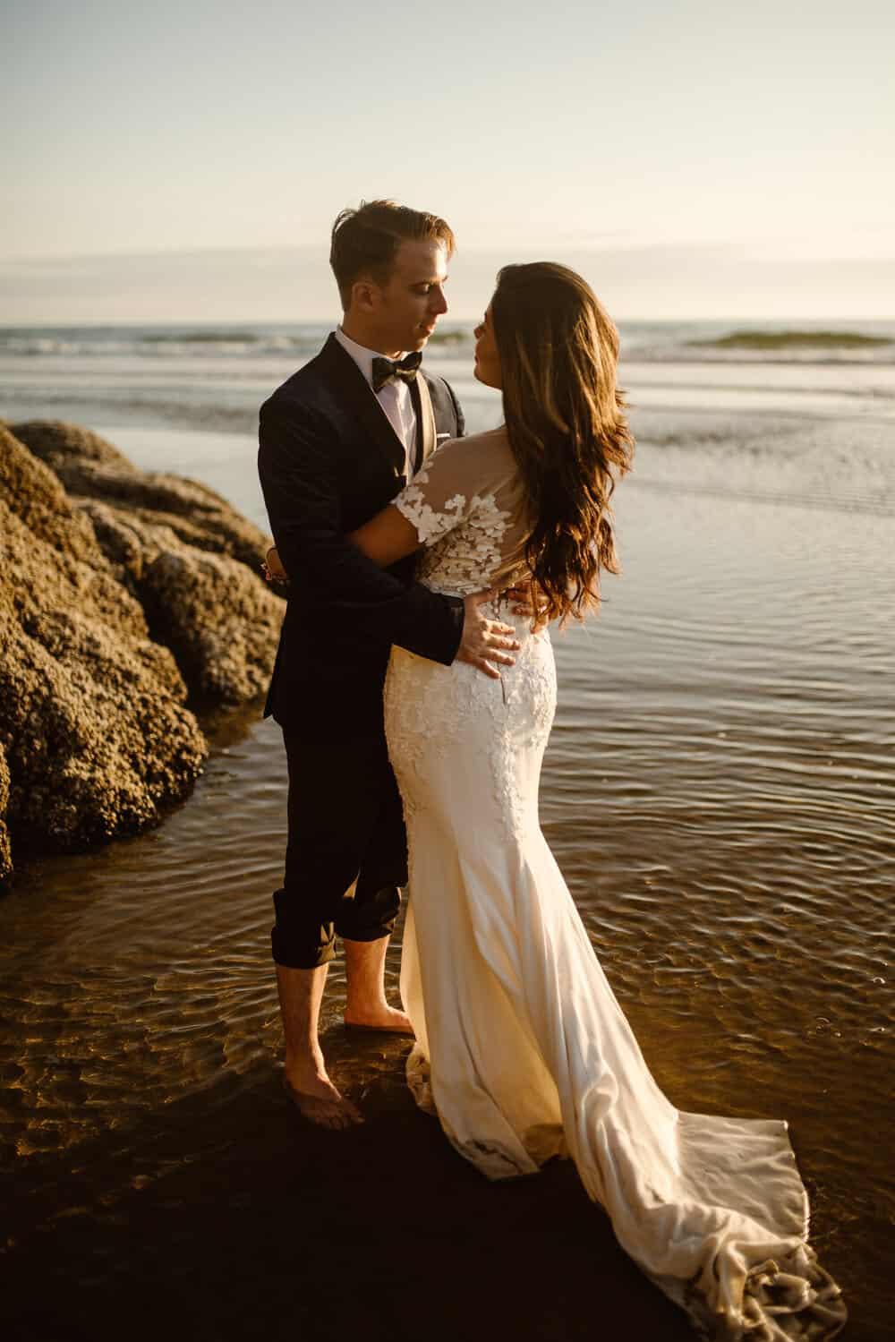 bride and groom embracing on the beach during their elopement along the Oregon coast.