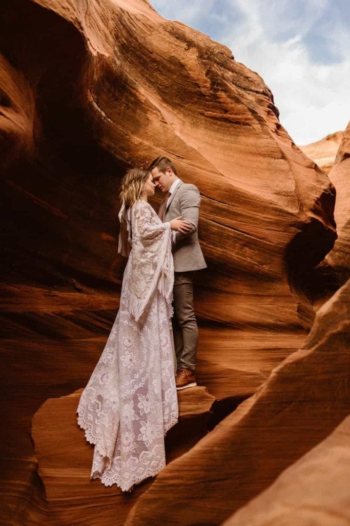A couple holds each other close while standing in a slot canyon in Page, Arizona. 