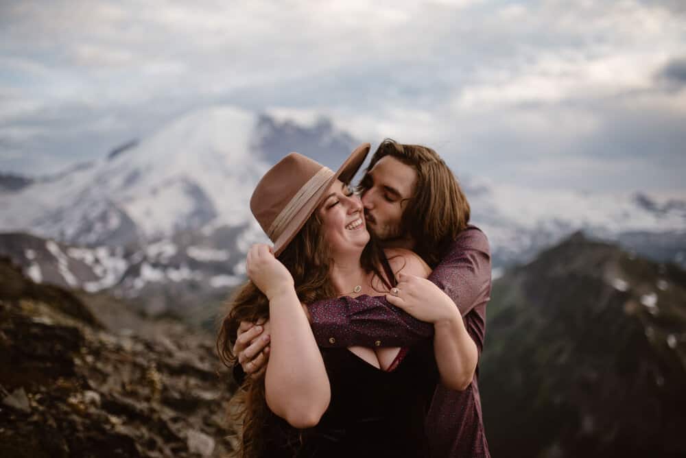 A couple shares a hug and kiss at Mt Rainier National Park. 