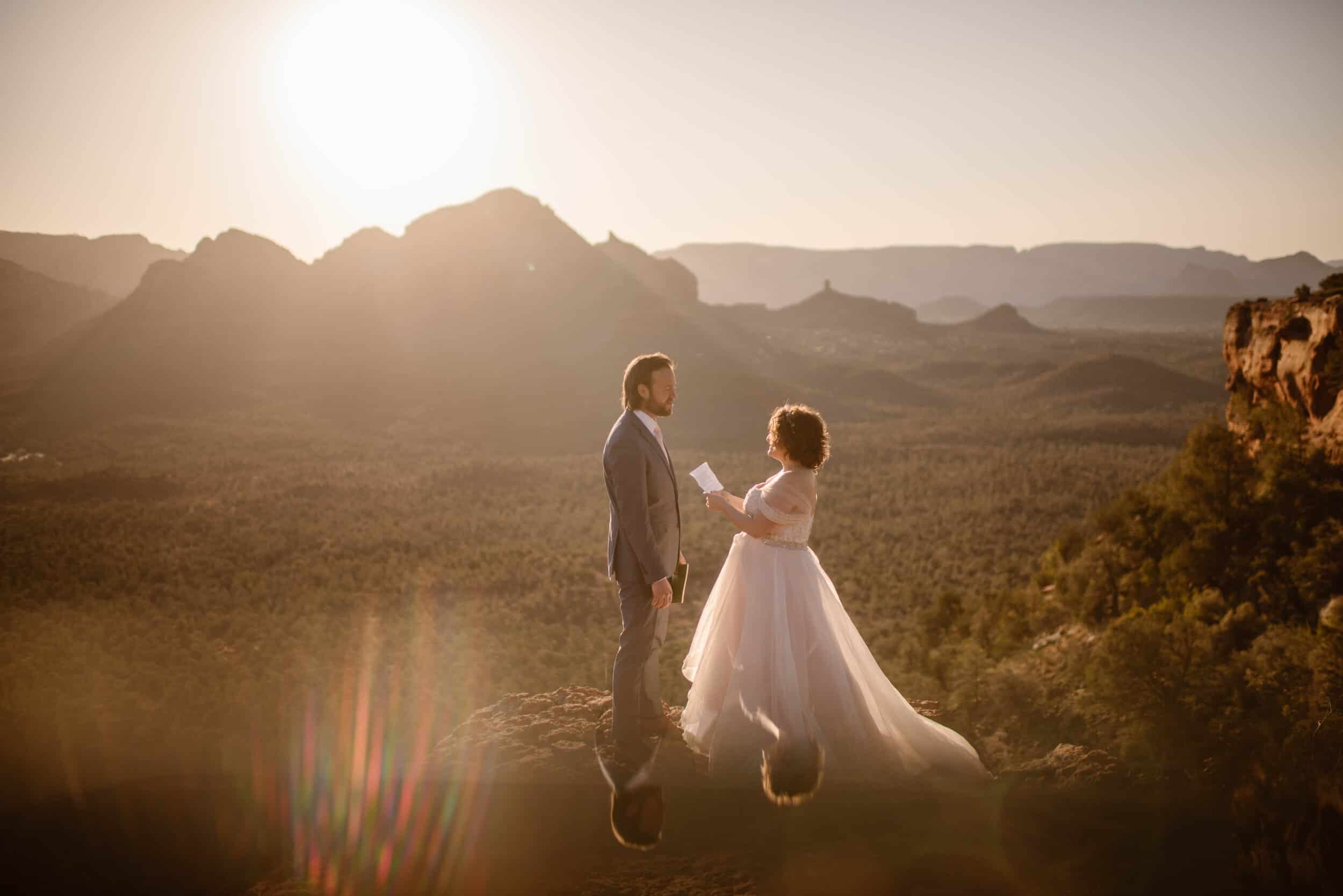 A pregnant bride and her groom share their private vows as the sun rises over Sedona.