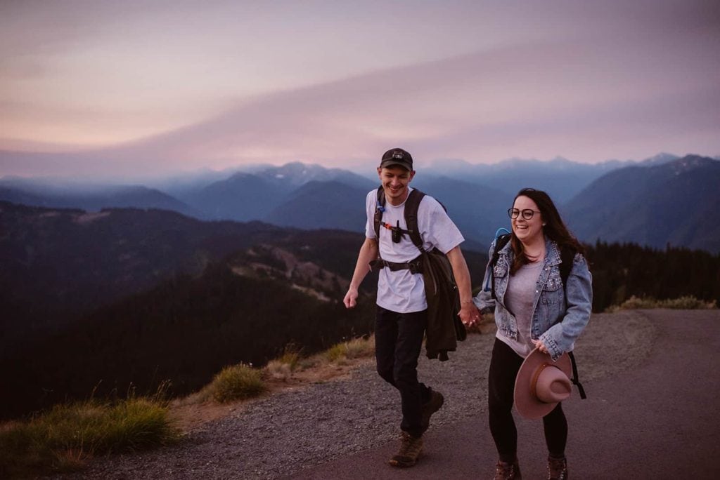 A couple hiking together at sunrise on their way up to their elopement ceremony location.