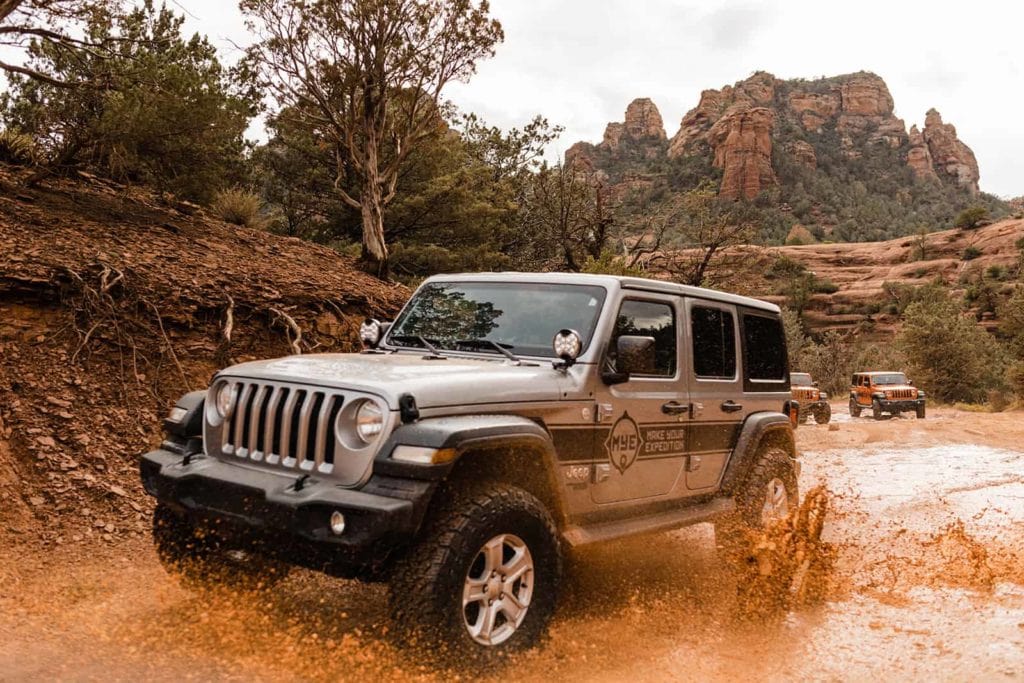 A jeep driving through mud on the dirt roads of Sedona 