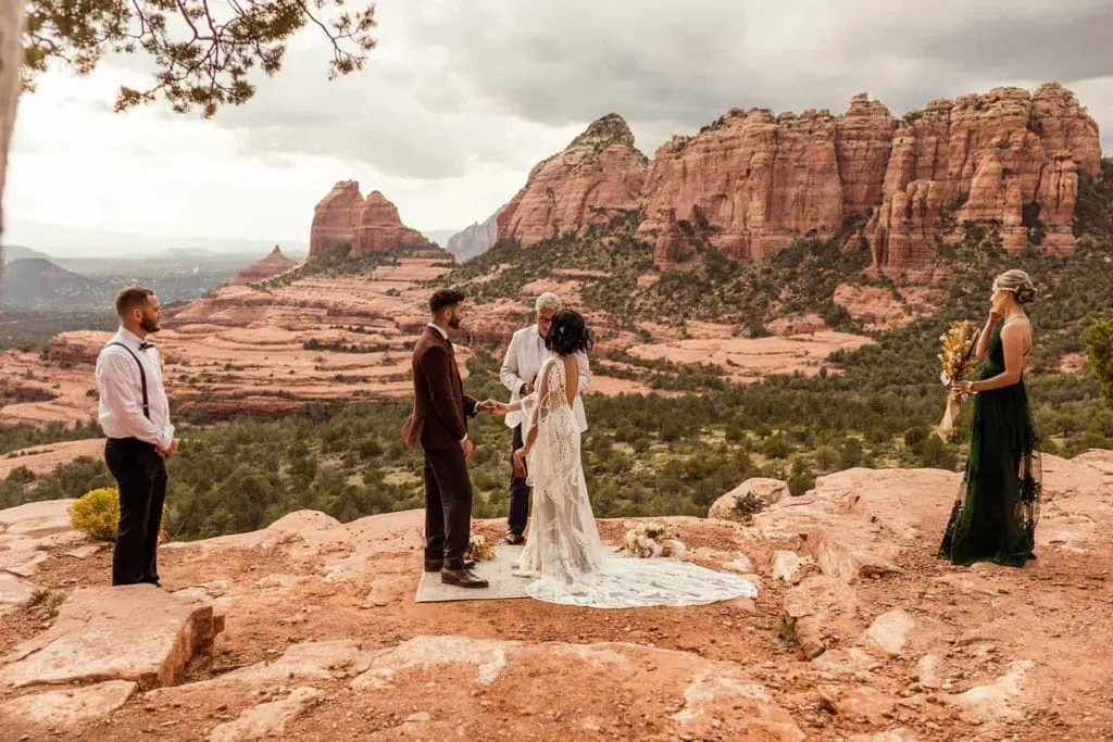 The bride and groom have their wedding officiated among the red rock views of Sedona.