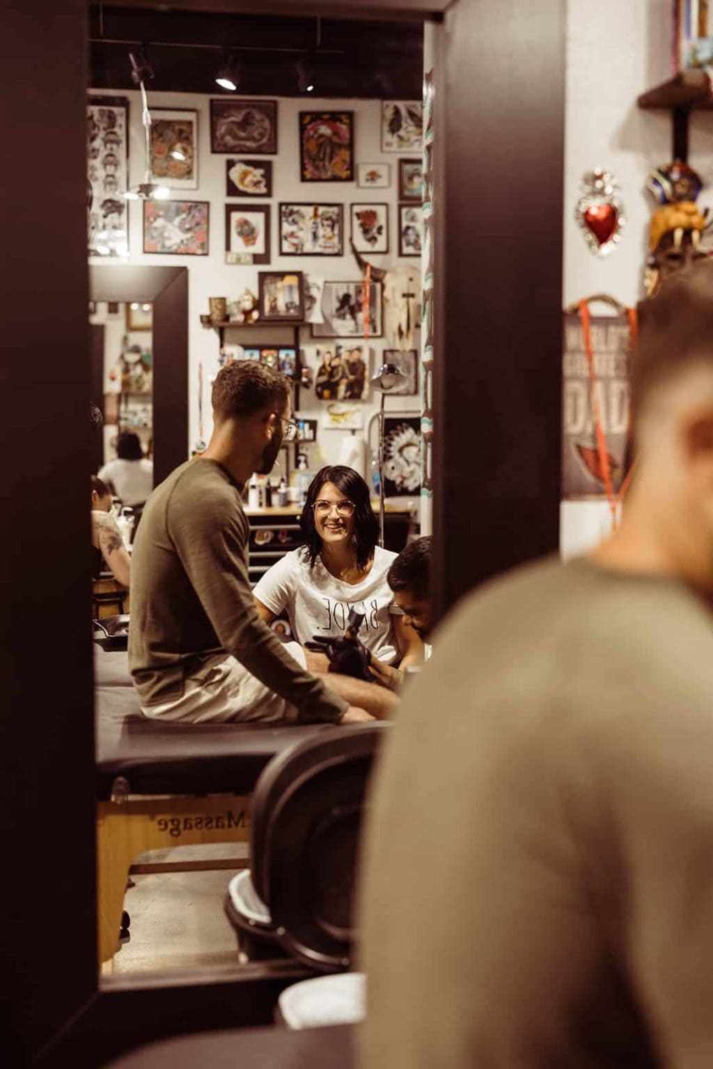 An engaged couple spending time together getting a tattoo to prepare for their wedding day