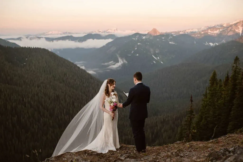 A couple exchanges vows at a private vista in Mount Rainier at sunrise.