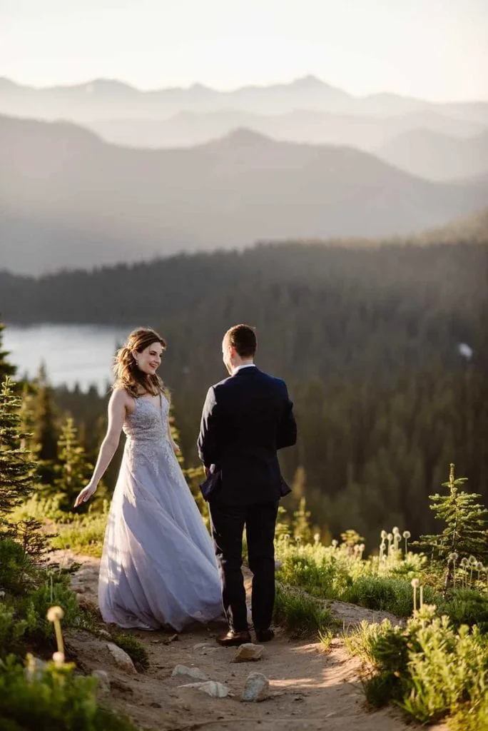 A bride and groom share a first look at sunrise in Mount Rainier.