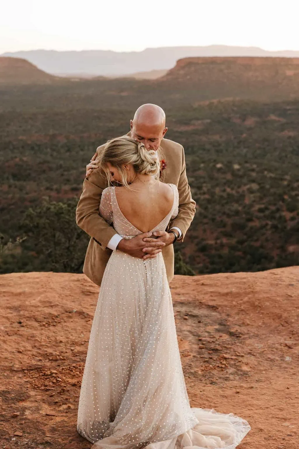 A bride and groom hold each other close in Sedona.
