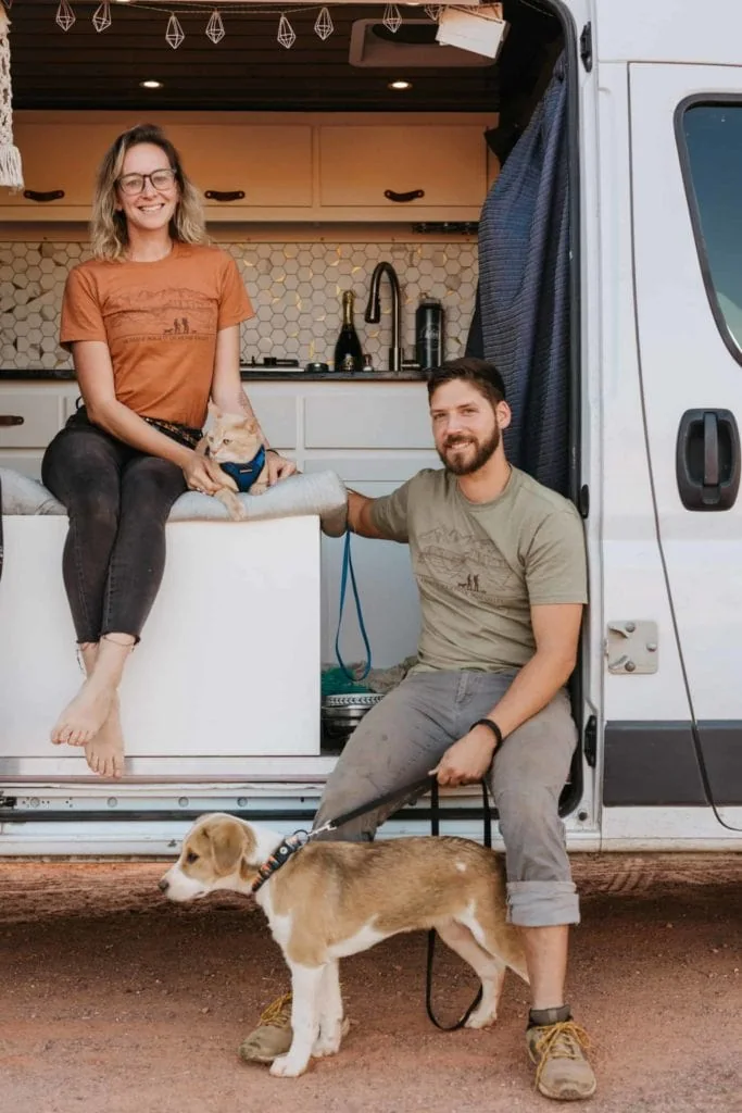 bill and traci in their van, with indy and tucker by their sides.