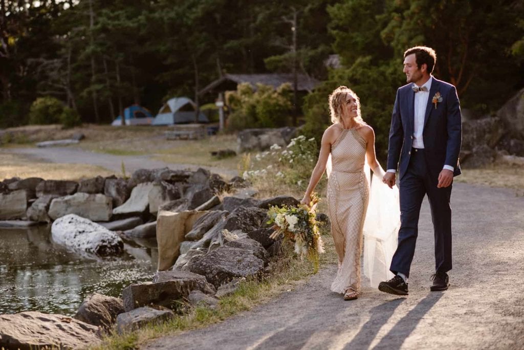 A couple walks together on the way to their elopement ceremony on Sucia Island.