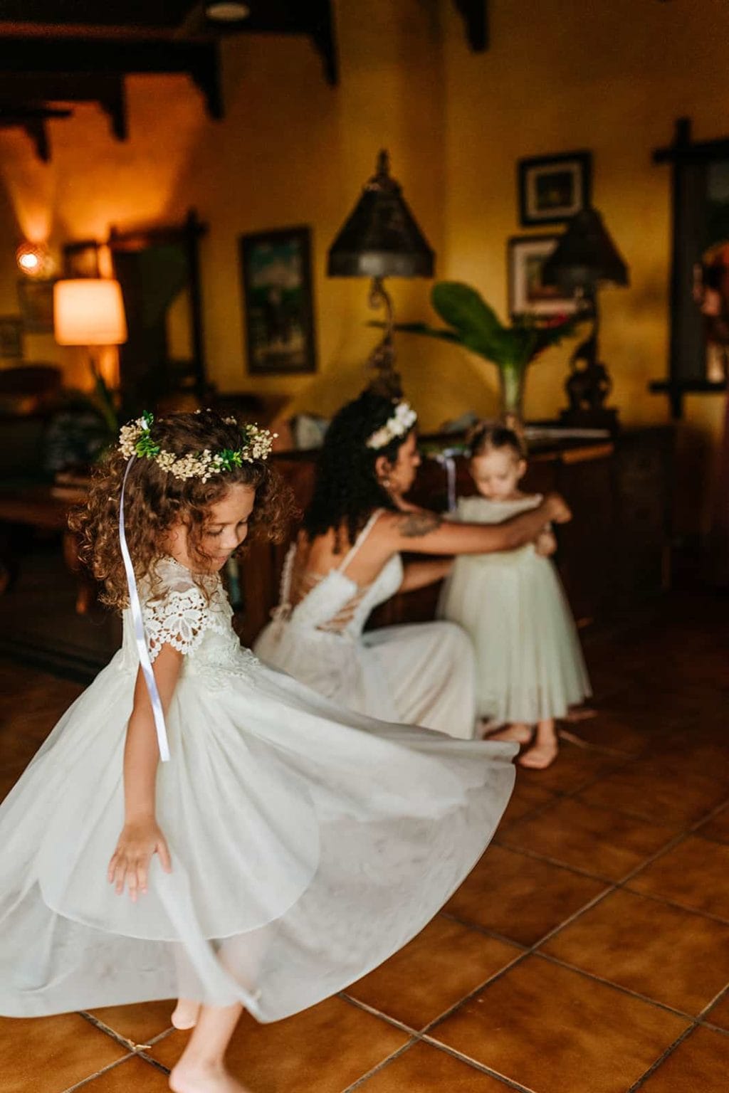The flower girl spins in her dress before the ceremony.