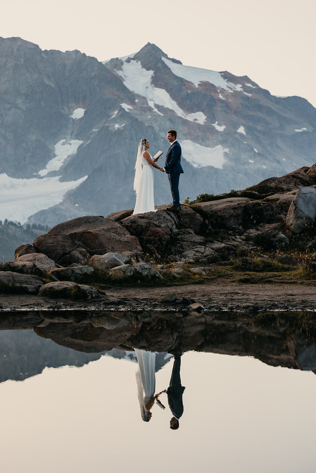A couple shares their vows at artist point at sunrise.
