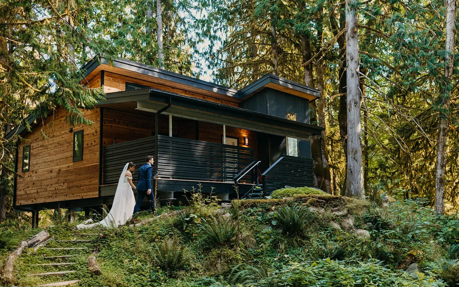 A couple walks together up to their Airbnb after their elopement in the mountains.