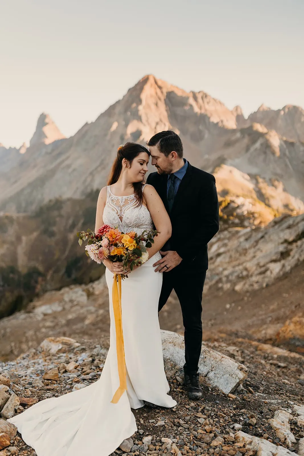 A couple brings their foreheads together for a romantic portrait in the mountains.