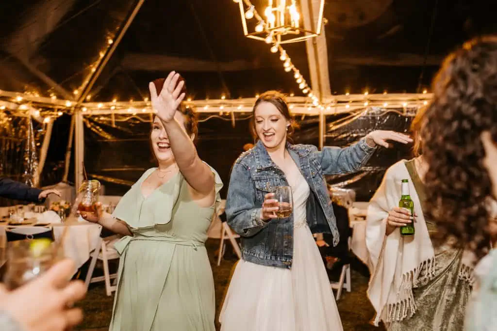 A bride dancing with her friend.