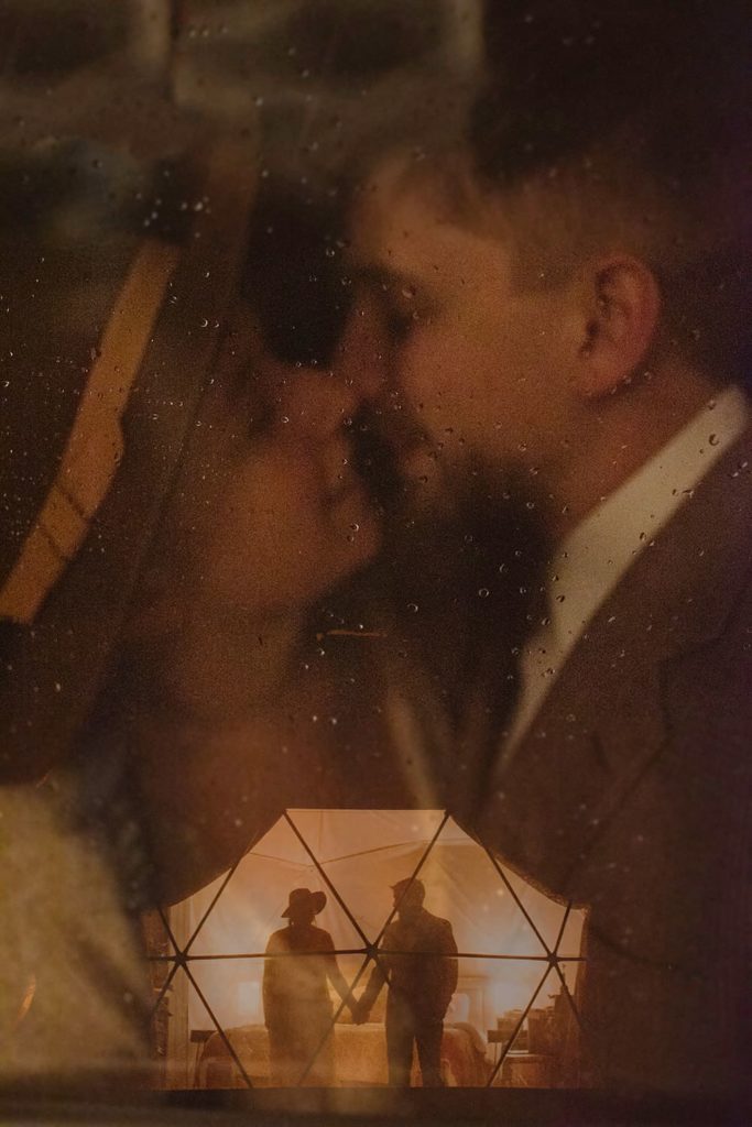 a couple kissing, with a double exposure of them holding hands at bottom.
