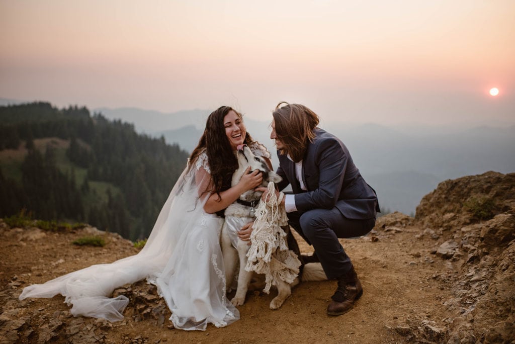 a couple loves up on their husky in their best attire at Leavenworth