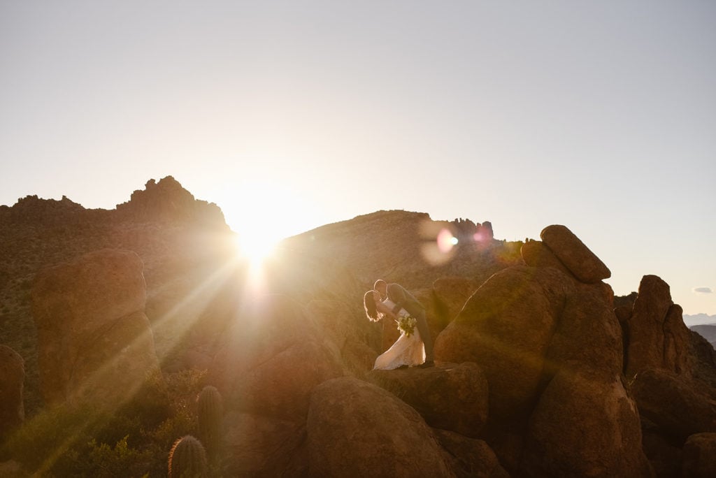 a dip kiss between husband and wife on superstition mountain.