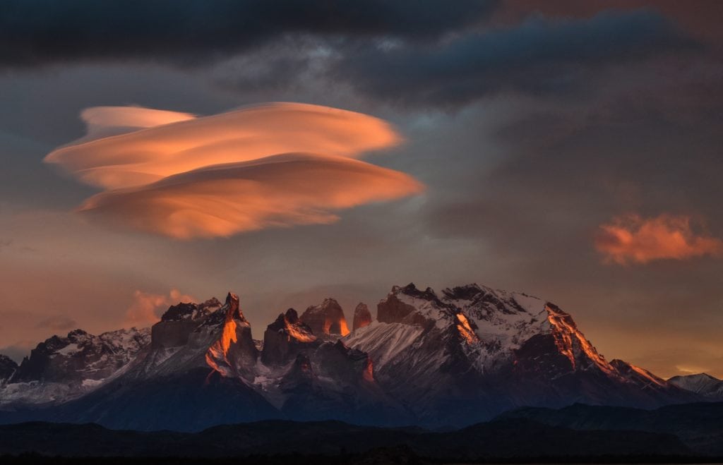 The sky turns pink as the last light touches the mountain peaks in Patagonia.