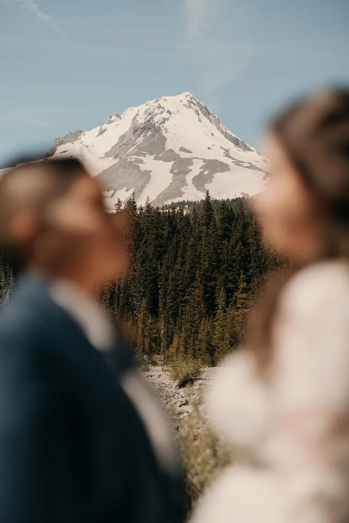 A detail photo of Mt Hood as the couple faces each other. 