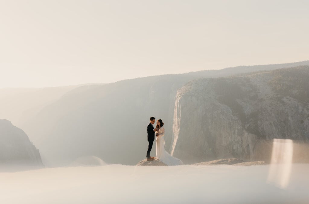 A couple reads their vows to each other at Taft Point in Yosemite for their wedding. 