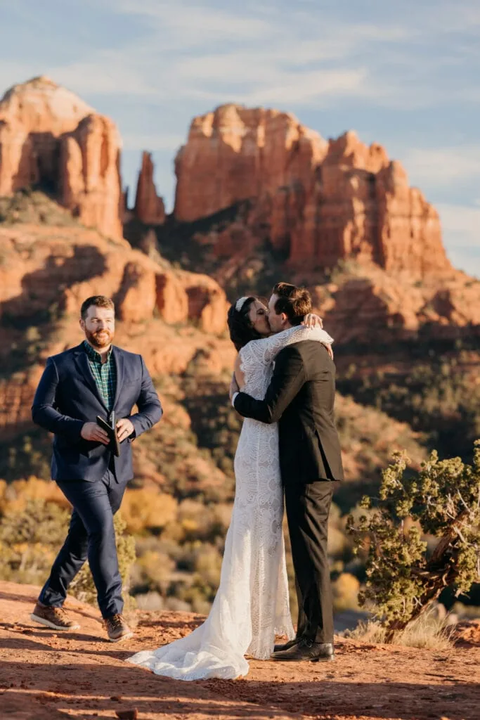 A bride and groom share their first kiss in Sedona