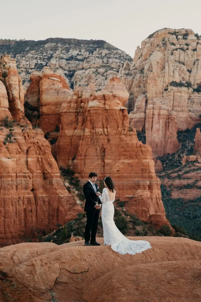 A bride and groom share personal vows at sunrise in Sedona.