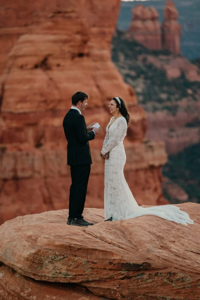 A bride and groom share personal vows at sunrise in Sedona.