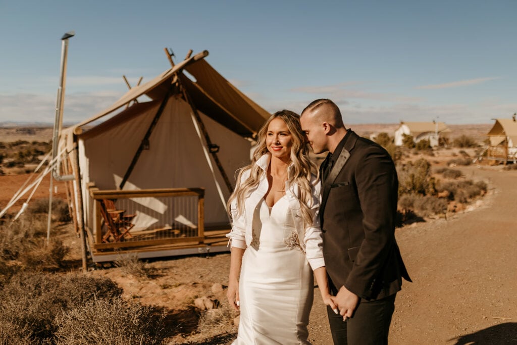 A couple walks around Under Canvas in Moab on their wedding day. 