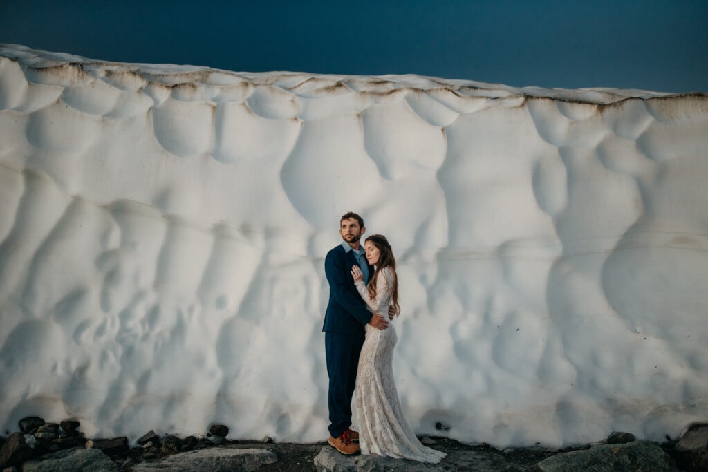 A snowy glacier elopement with a couple at the first light in the morning. 