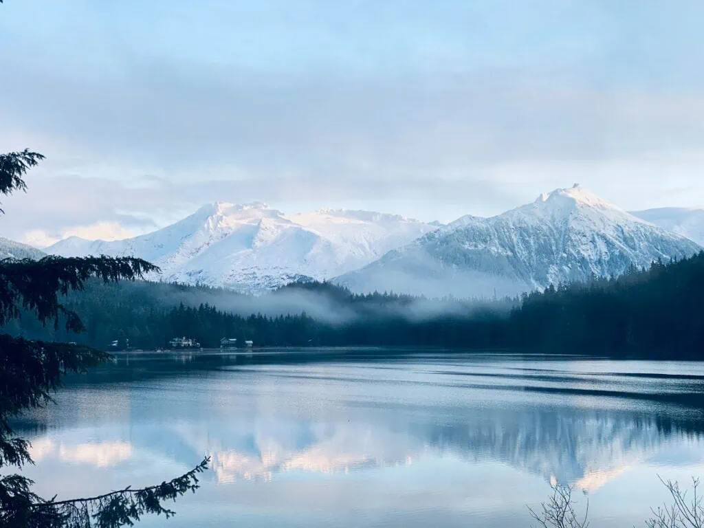 A lake view with mountains covered in snow in Alaska.
