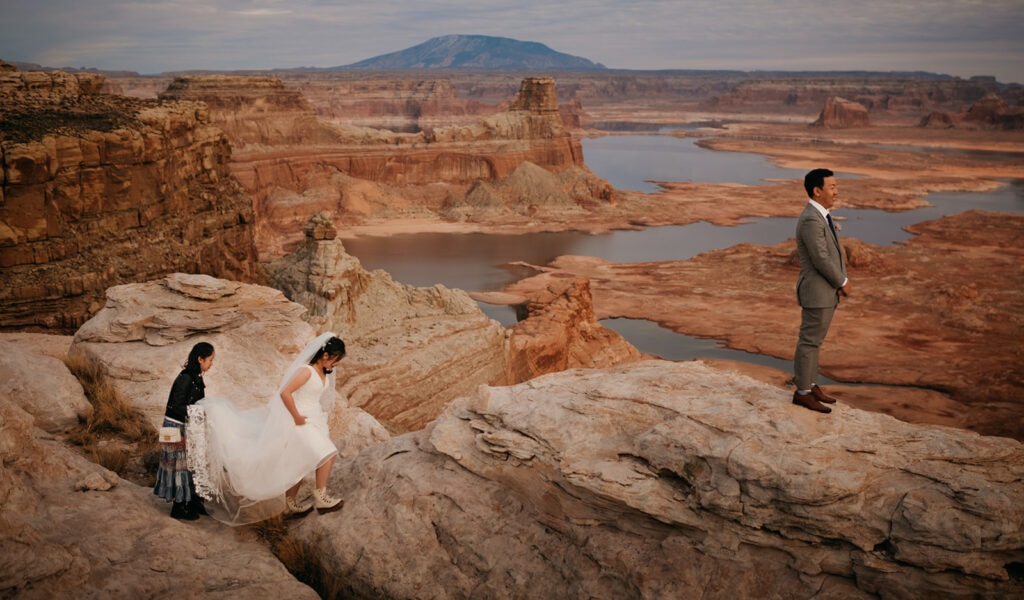 A bride walks to her groom for the first look at their wedding in the desert.