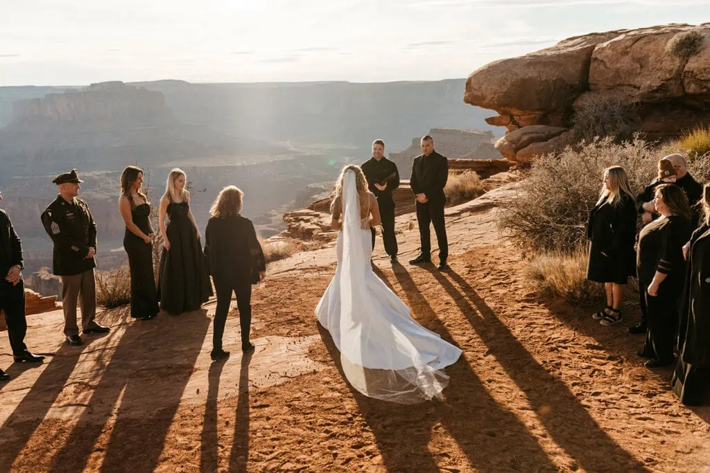 The bride joins the elopement ceremony on the edge of a cliff. 
