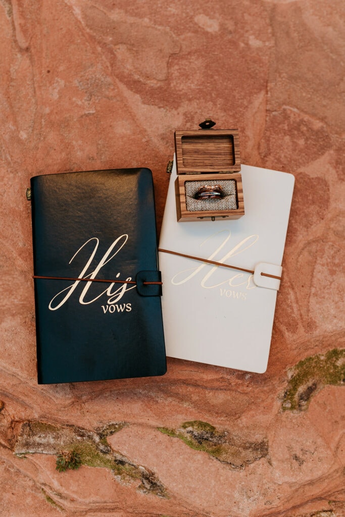 A detail photo of the couples vow books and ring.