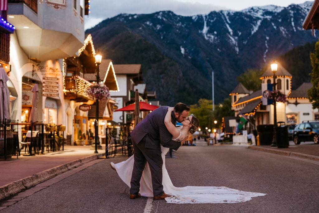 A couple shares a dip kiss in the night street of Downtown Leavenworth
