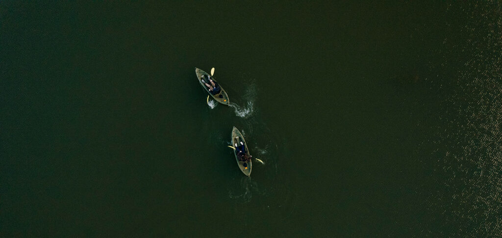 A view above of two kayakers on a lake. 