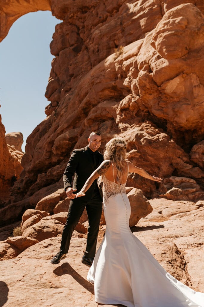A bride and groom sharing a first look in arches national park