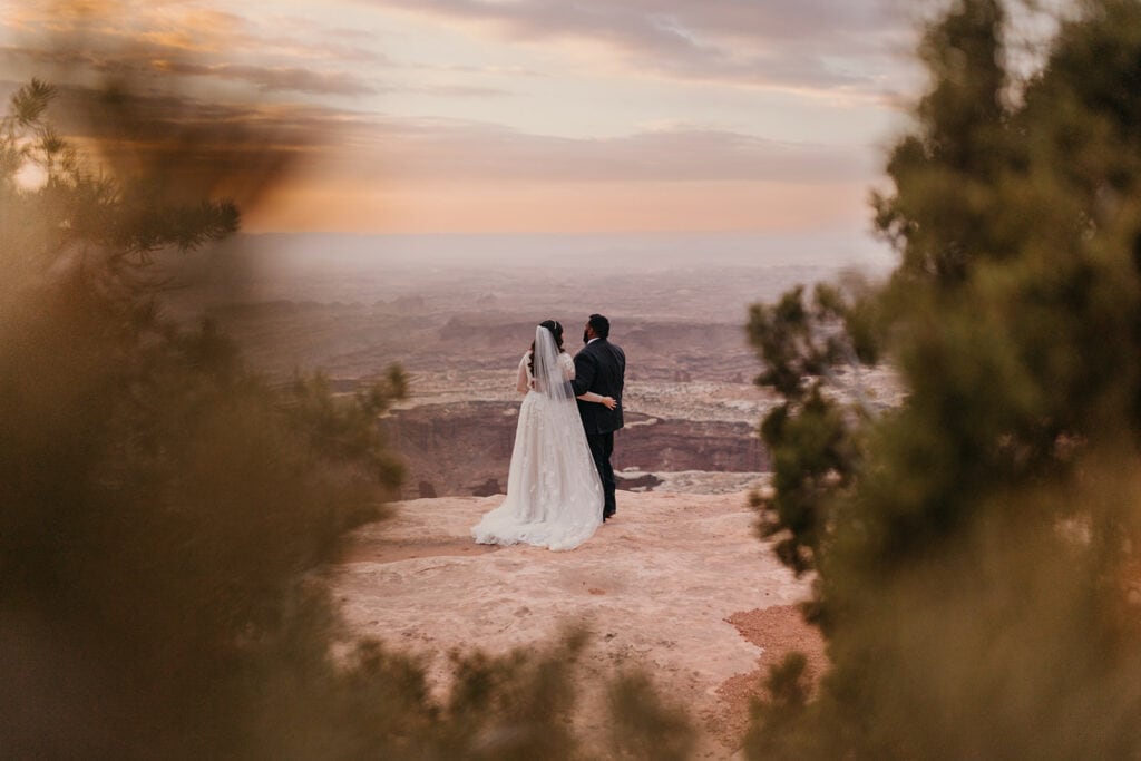 A couple watches the sunrise in Canyonlands after their first look.