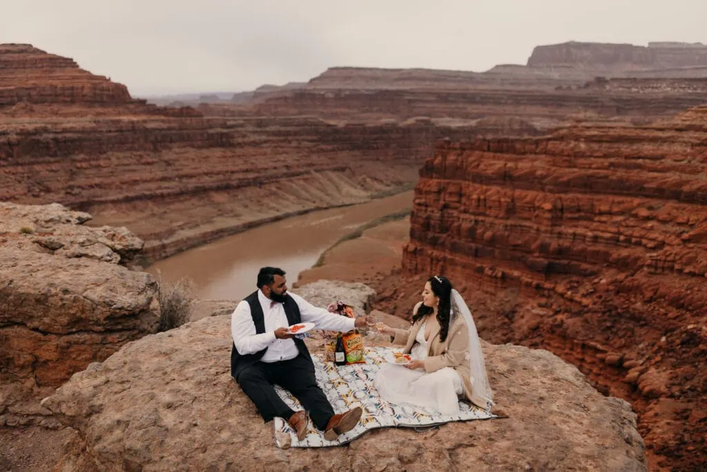 A couple has a picnic during their elopement in Canyonlands.