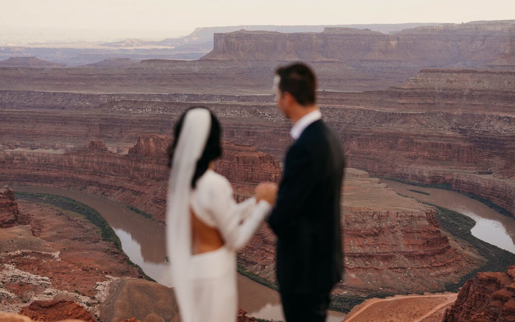 A couple looks out at the canyon below.