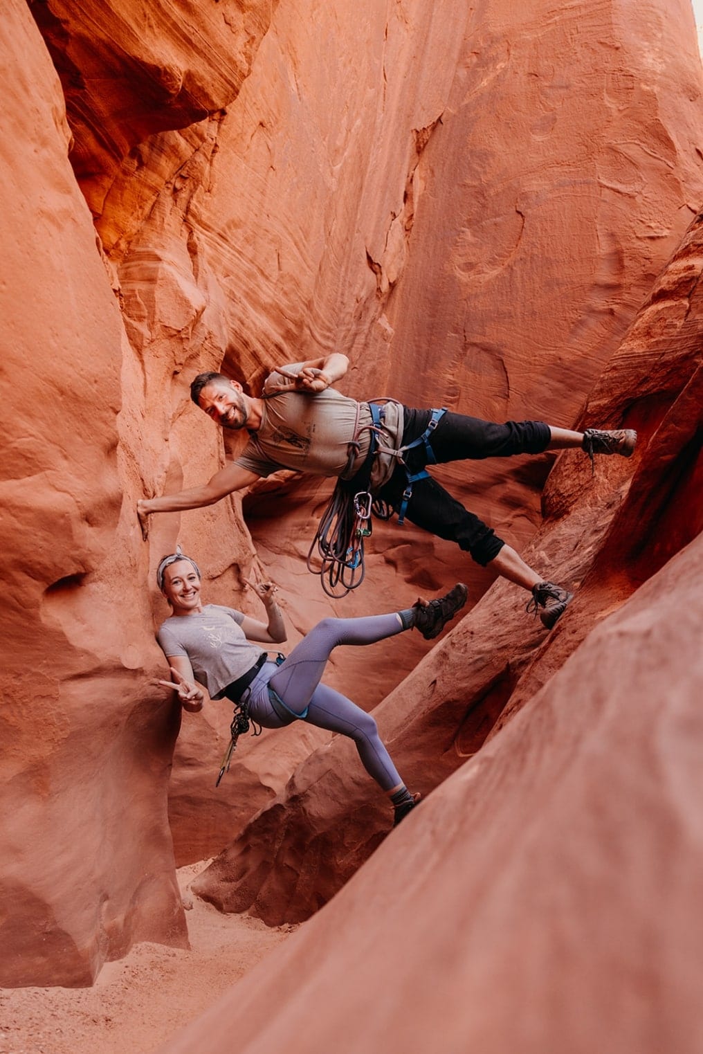 A portrait of an adventure elopement photography team in a slot canyon.