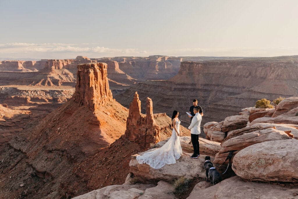 The couple shares vows during their ceremony overlooking a canyon.