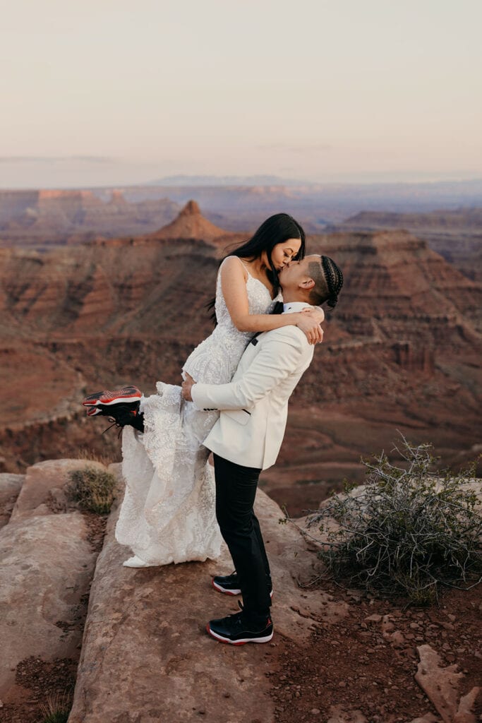 The couple shares a kiss showing off their Jordan shoes.
