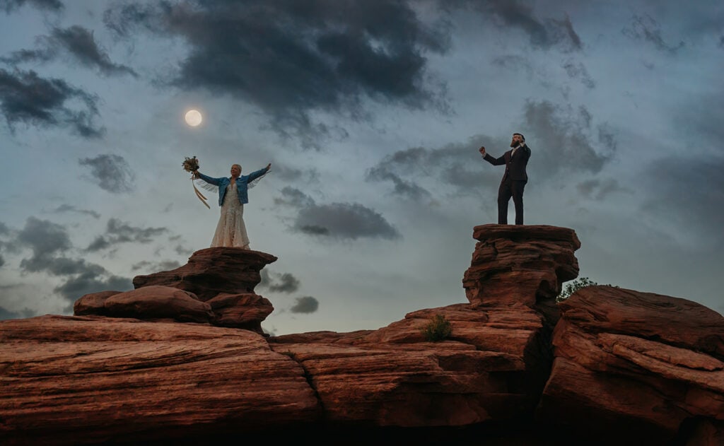 A bride and groom celebrate together at Dead Horse Point at Sunset