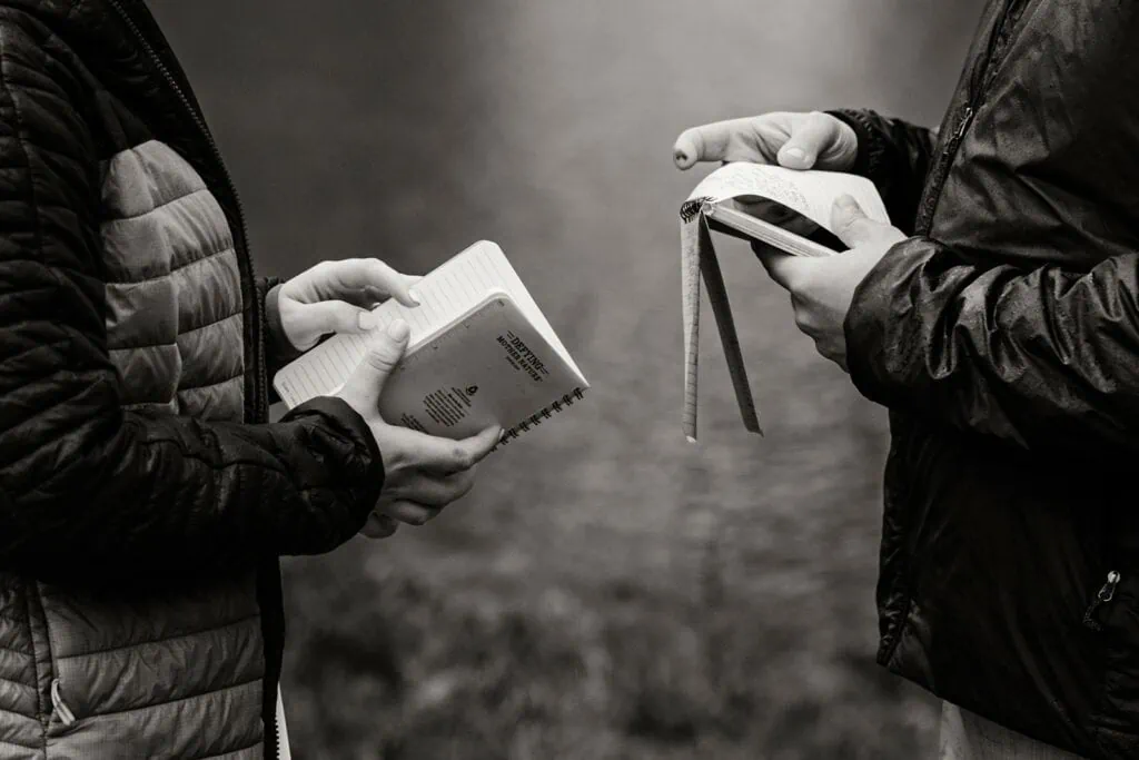 A detail photo of the couple holding their vow books.